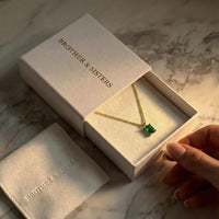 Thumbnail for Emerald Pendant Necklace in gold setting by Brother & Sisters, presented in elegant packaging.