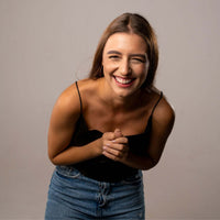 Thumbnail for Smiling woman in casual attire, showcasing joy and happiness, ideal for lifestyle and fashion content.