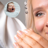 Thumbnail for Close-up of a woman wearing the Tulip Photo Bracelet, showcasing a hidden photo projection of a yawning baby.