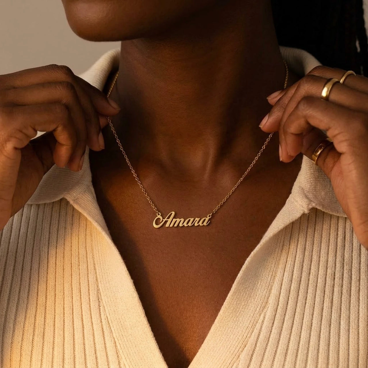 Minimalist Name Necklace in gold with the name Amara, held at the neckline with both hands | SKU: minimalistnn-gold