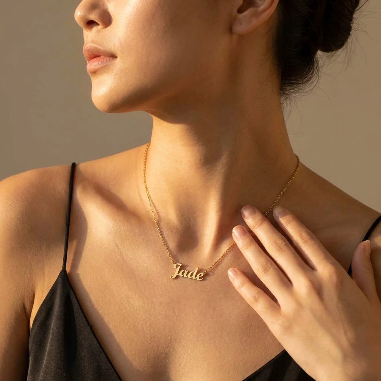 Minimalist Name Necklace in gold with the name Jade, worn in three-quarter profile | SKU: minimalistnn-gold
