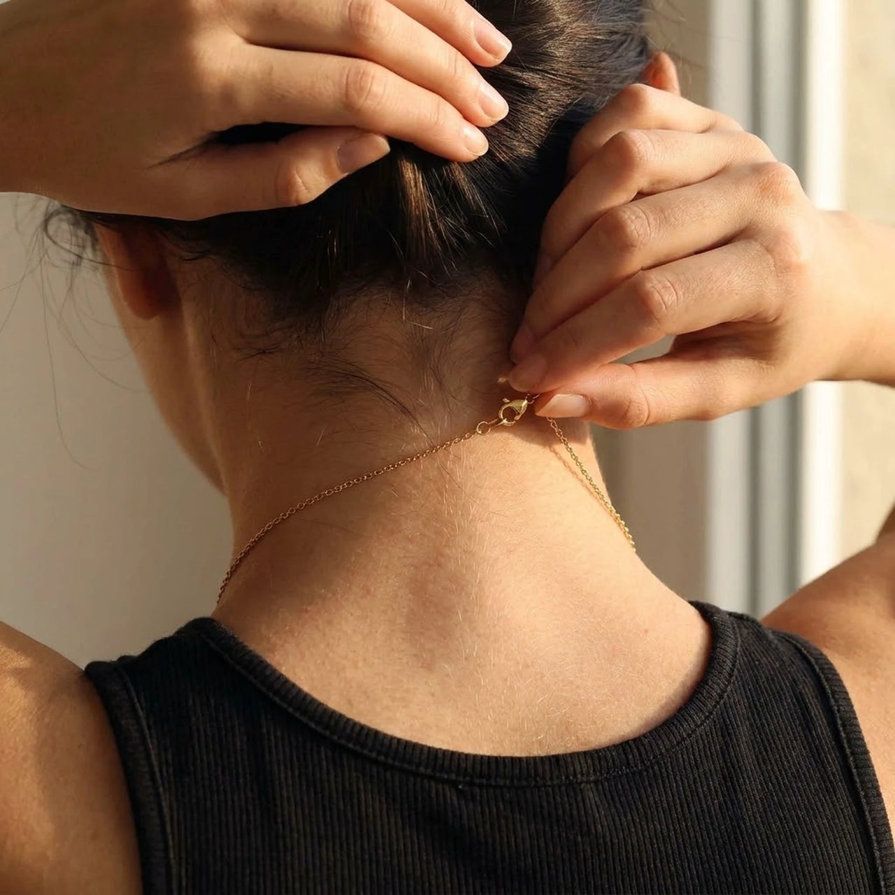 Minimalist Name Necklace being fastened at the nape, clasp and chain visible | SKU: minimalistnn-gold