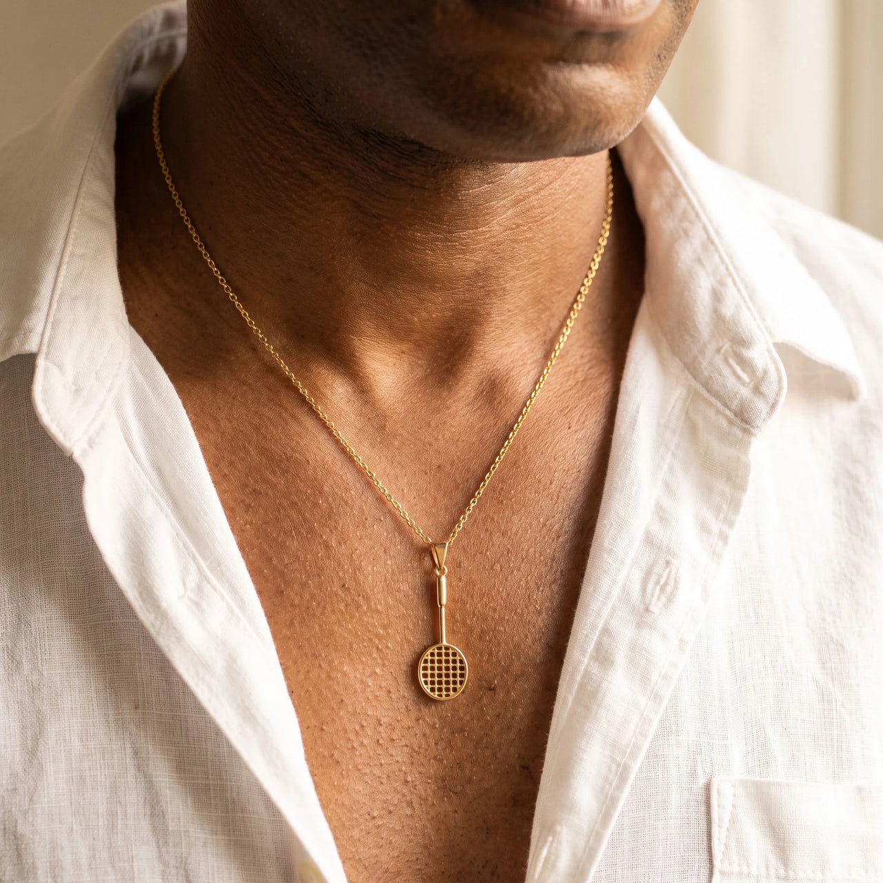 Badminton Racket Necklace Gold – close-up worn on a man's wrist | Brother & Sisters | SKU: Gold