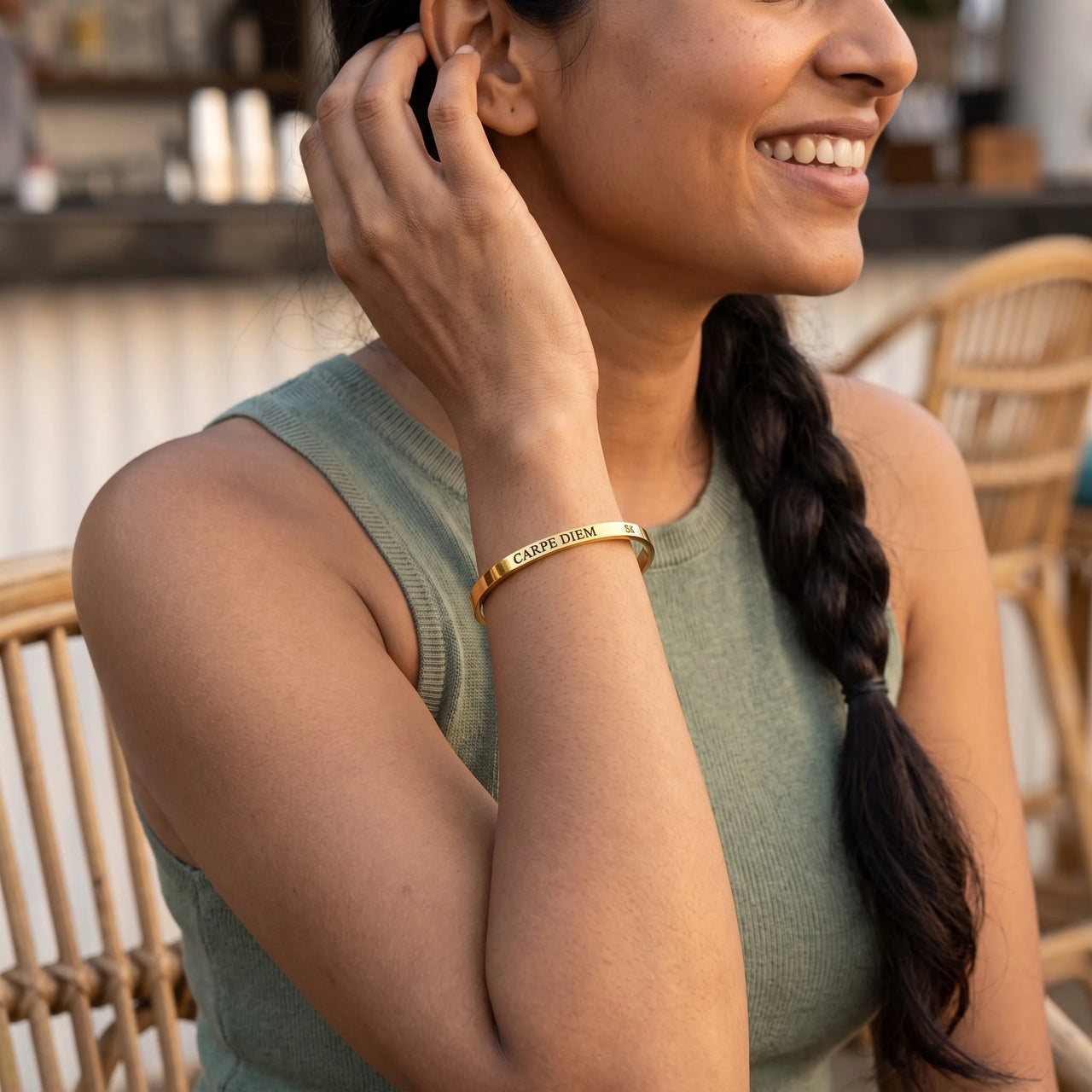 Woman gently touching her Carpe Diem bracelet in gold | SKU: cp-g