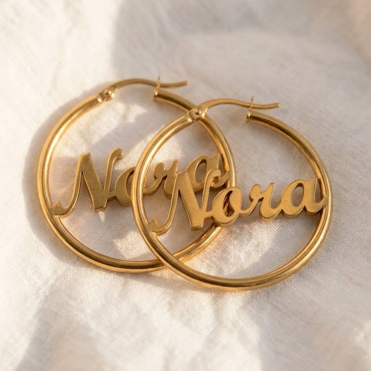 Custom Name Hoop Earrings in Gold, macro detail of the metal and the finish | SKU: name-hoop-gold-30-mm