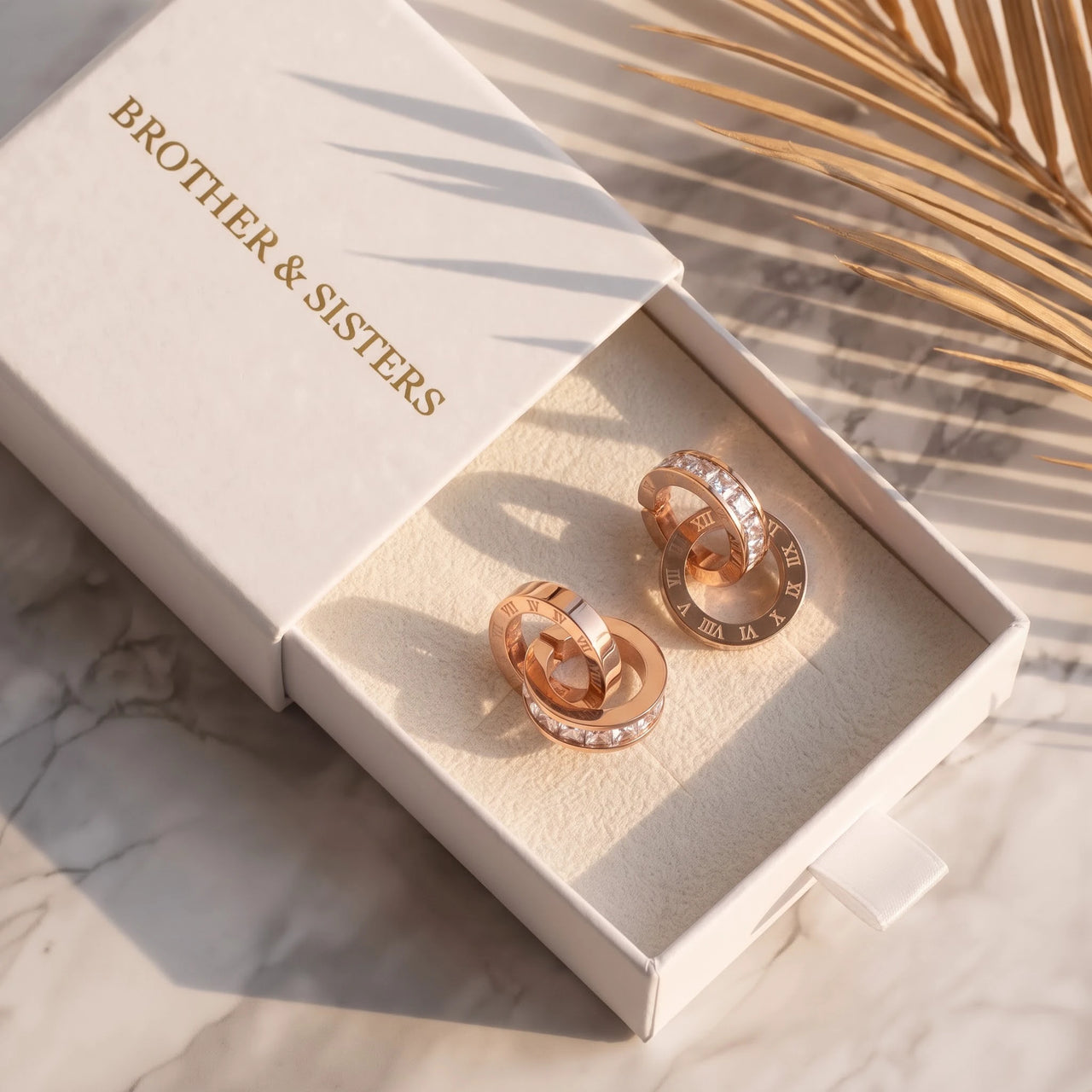 Rose gold huggie hoop earrings in the Brother & Sisters gift box | SKU: 11137578-rose-gold