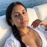 Thumbnail for Woman on a yacht wearing the rose gold huggie hoop earrings | SKU: 11137578-rose-gold