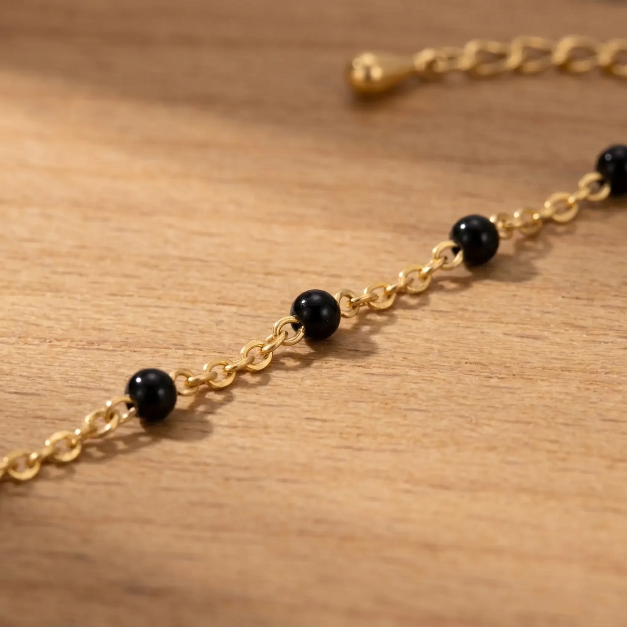 Gold & Onyx Bead Anklet features glossy black enamel beads on a gold chain by Brother & Sisters.