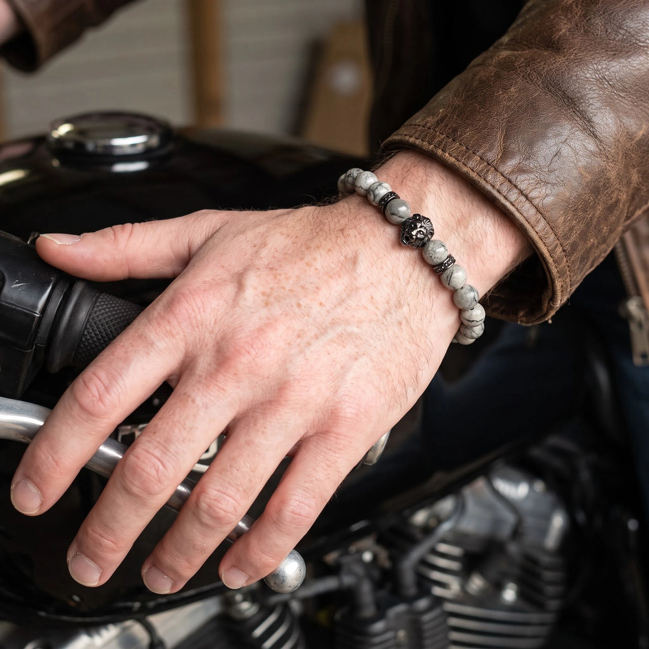Black Lion & Grey Stones Bracelet – close-up worn on a man's wrist | Brother & Sisters | SKU: 20866222-gun-black-XS-14-15, 20866222-gun-black-S-16-17, 20866222-gun-black-M-18-19, 20866222-gun-black-L-20-21, 20866222-gun-black-XL-22-23