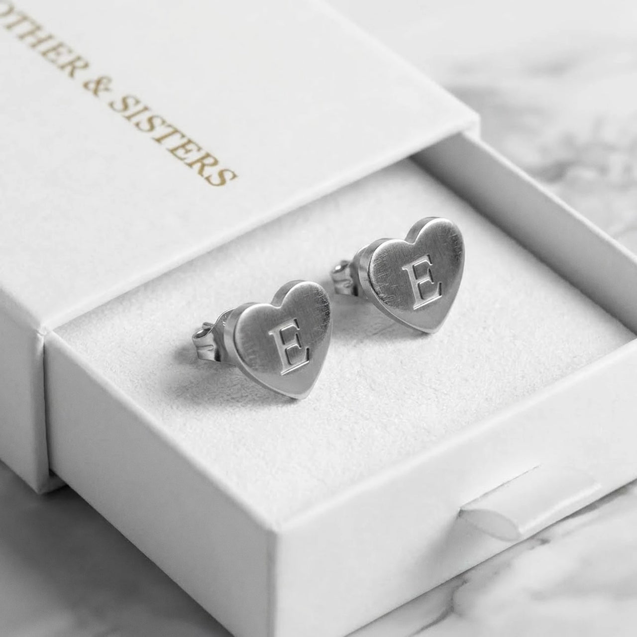 Heart Initial Stud Earrings in Silver in the Brother & Sisters gift box | SKU: heart-initial-silver-a