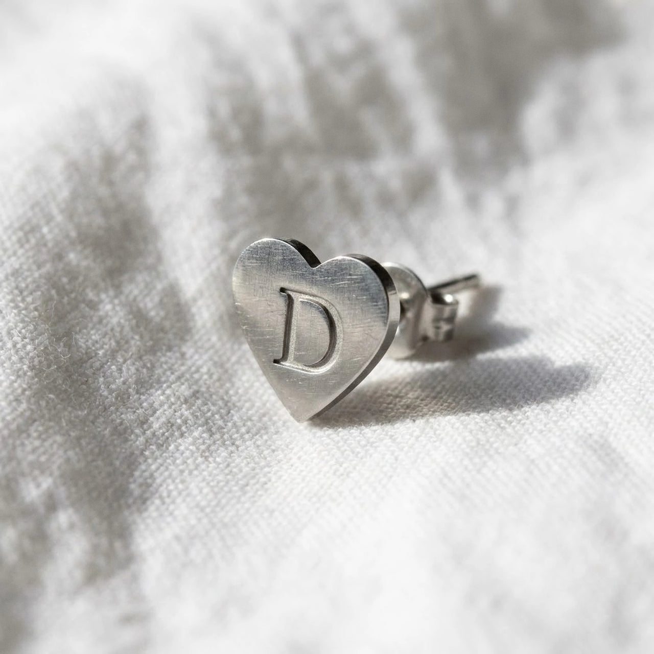 Heart Initial Stud Earrings in Silver, macro detail of the metal and the finish | SKU: heart-initial-silver-a