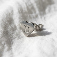 Thumbnail for Heart Initial Stud Earrings in Silver, macro detail of the metal and the finish | SKU: heart-initial-silver-a