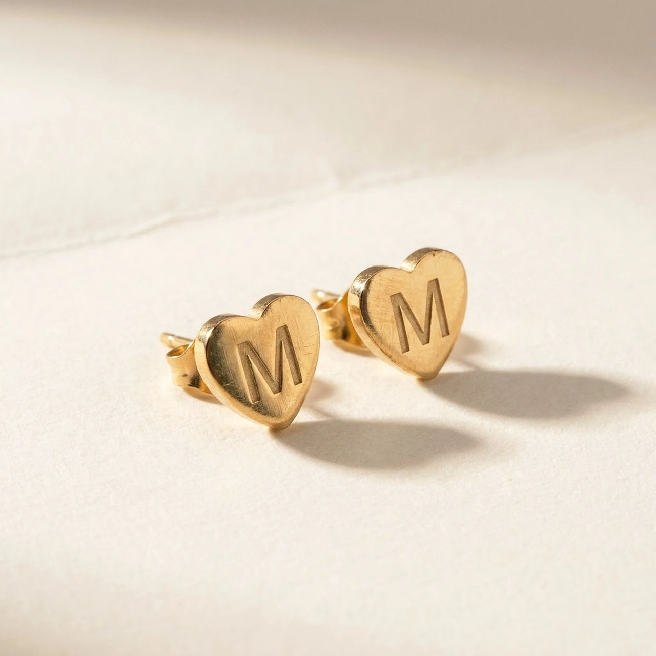 Heart Initial Stud Earrings in Gold, studio packshot of the pair on a plain background | SKU: heart-initial-gold-a
