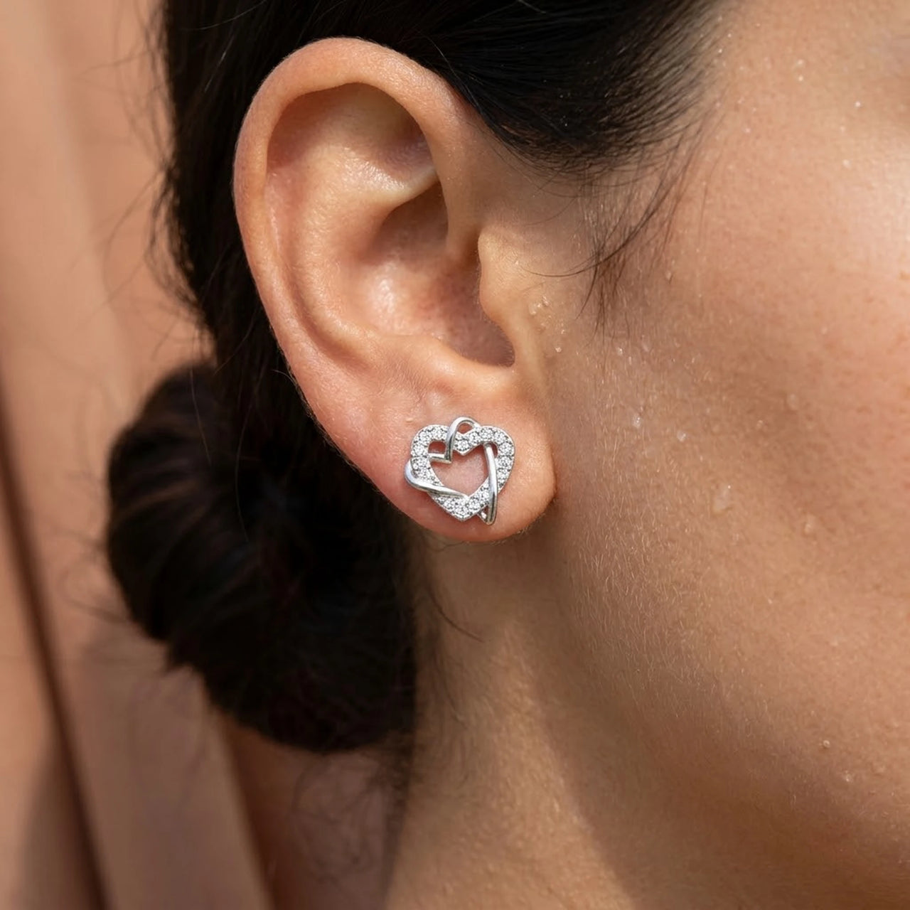 Close-up of the silver stud earrings worn on the skin | SKU: 4478648-platinum-plated-clear