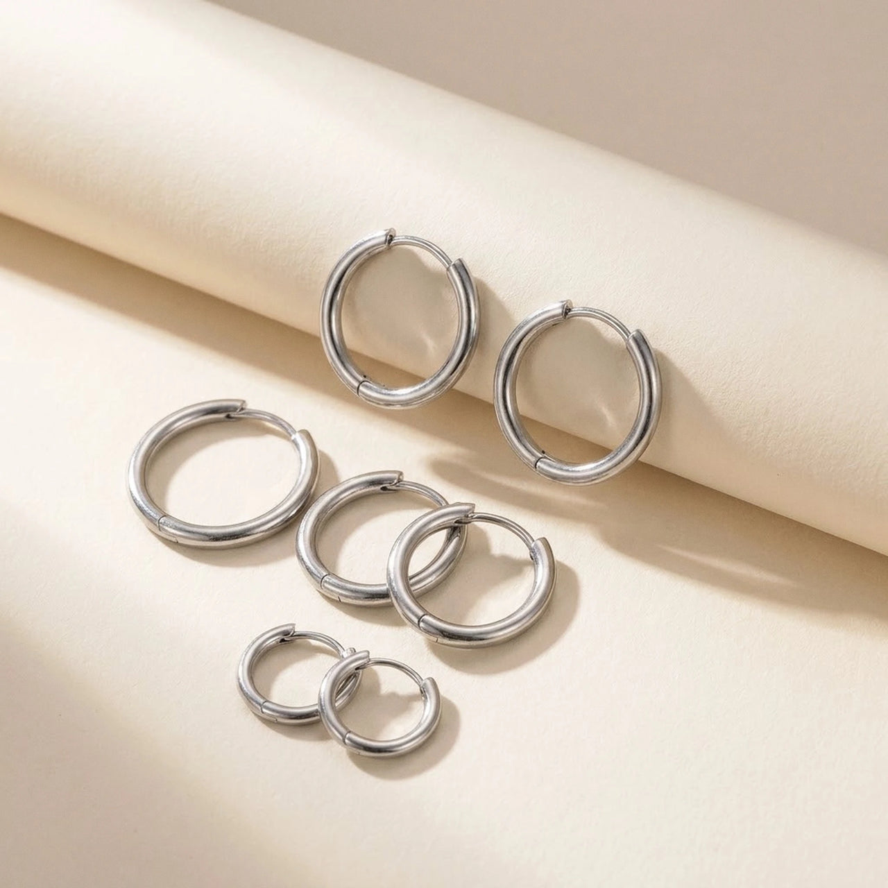 Huggie Hoop Earrings Set of 4 Pairs in Silver, studio packshot of the pair on a plain background | SKU: huggie-set-silver