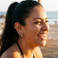 Thumbnail for Huggie Hoop Earrings Set of 4 Pairs in Silver worn outdoors, lifestyle shot | SKU: huggie-set-silver