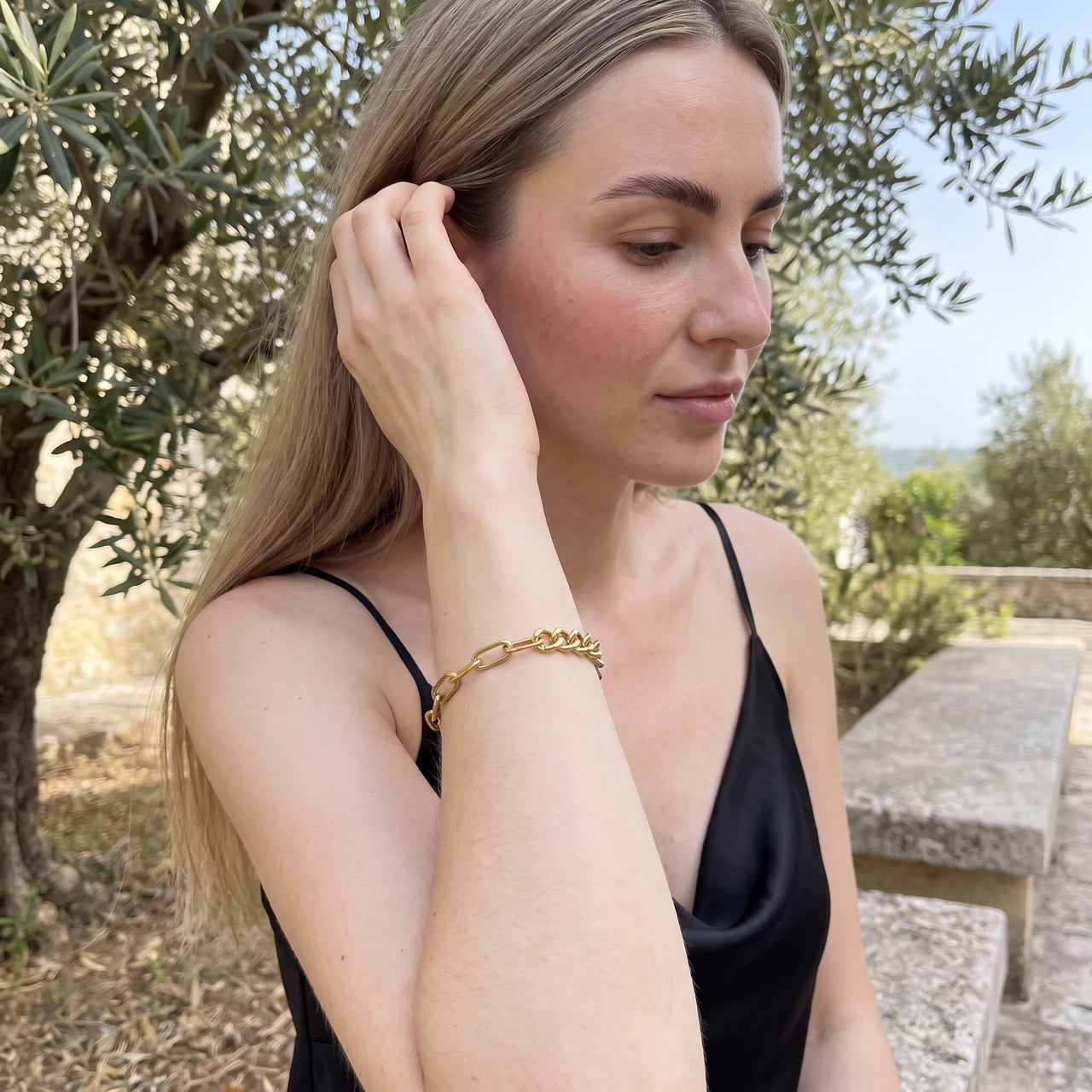 Woman gently touching her Double bracelet in gold | SKU: ledouble