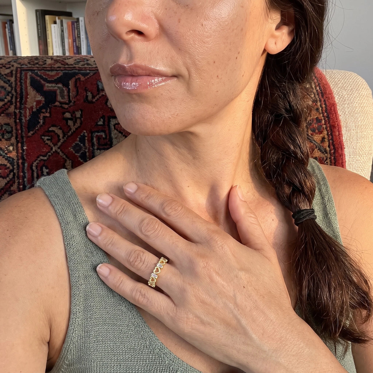 Woman gently touching her Hearts ring in gold | SKU: lescoeurs