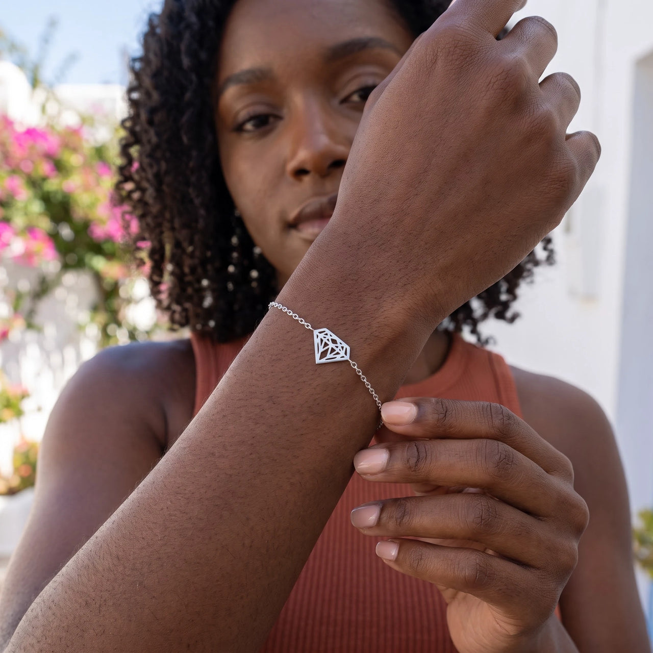 Woman gently touching her silver bracelet | SKU: 11662607-white-gold