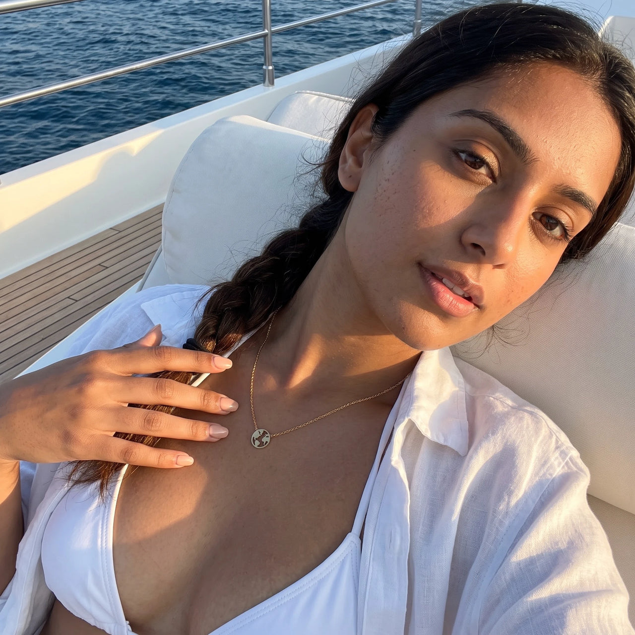 Woman on a yacht wearing the gold necklace | SKU: 22173453-gold
