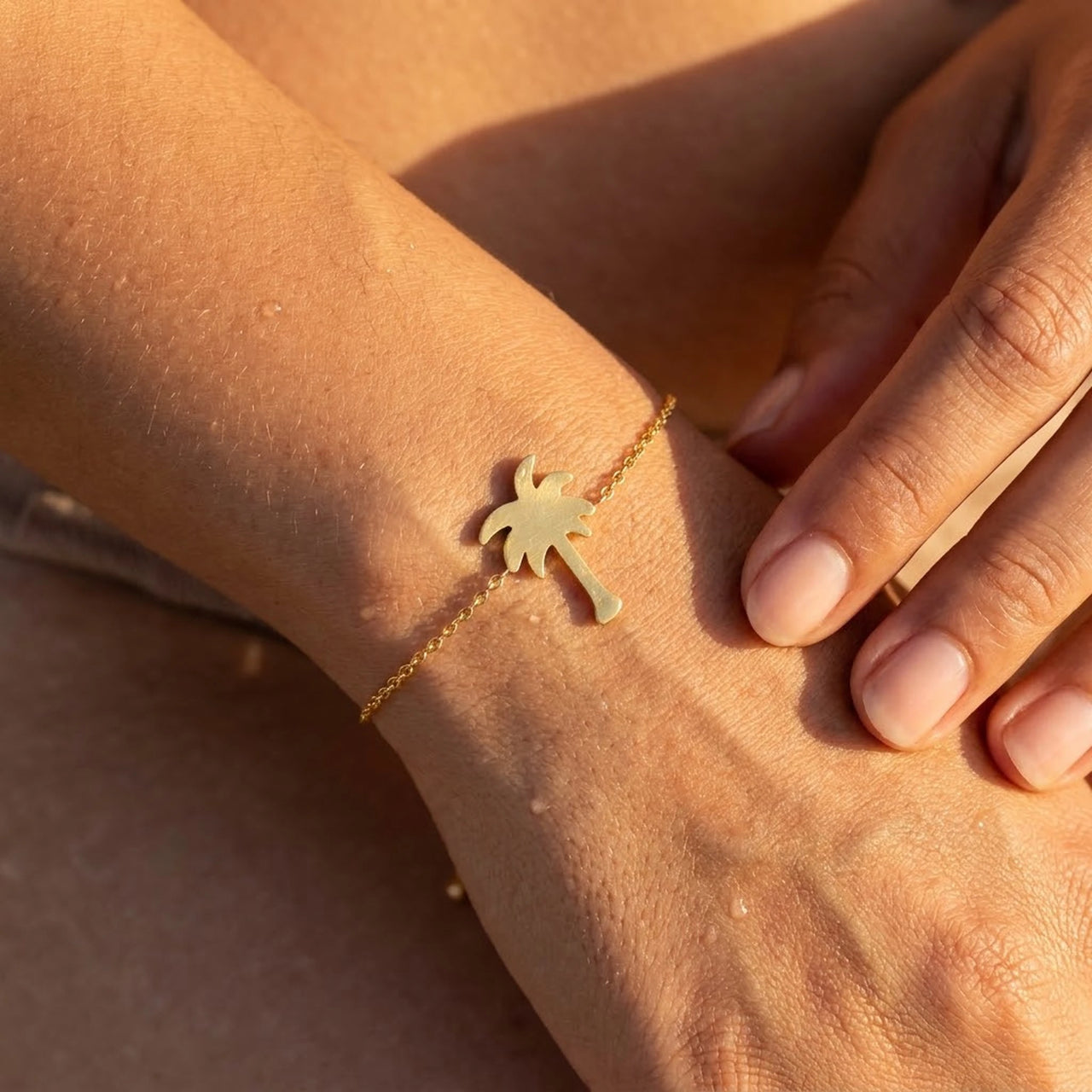 Close-up of the gold charm bracelet worn on the skin | SKU: 7819407-gold-color