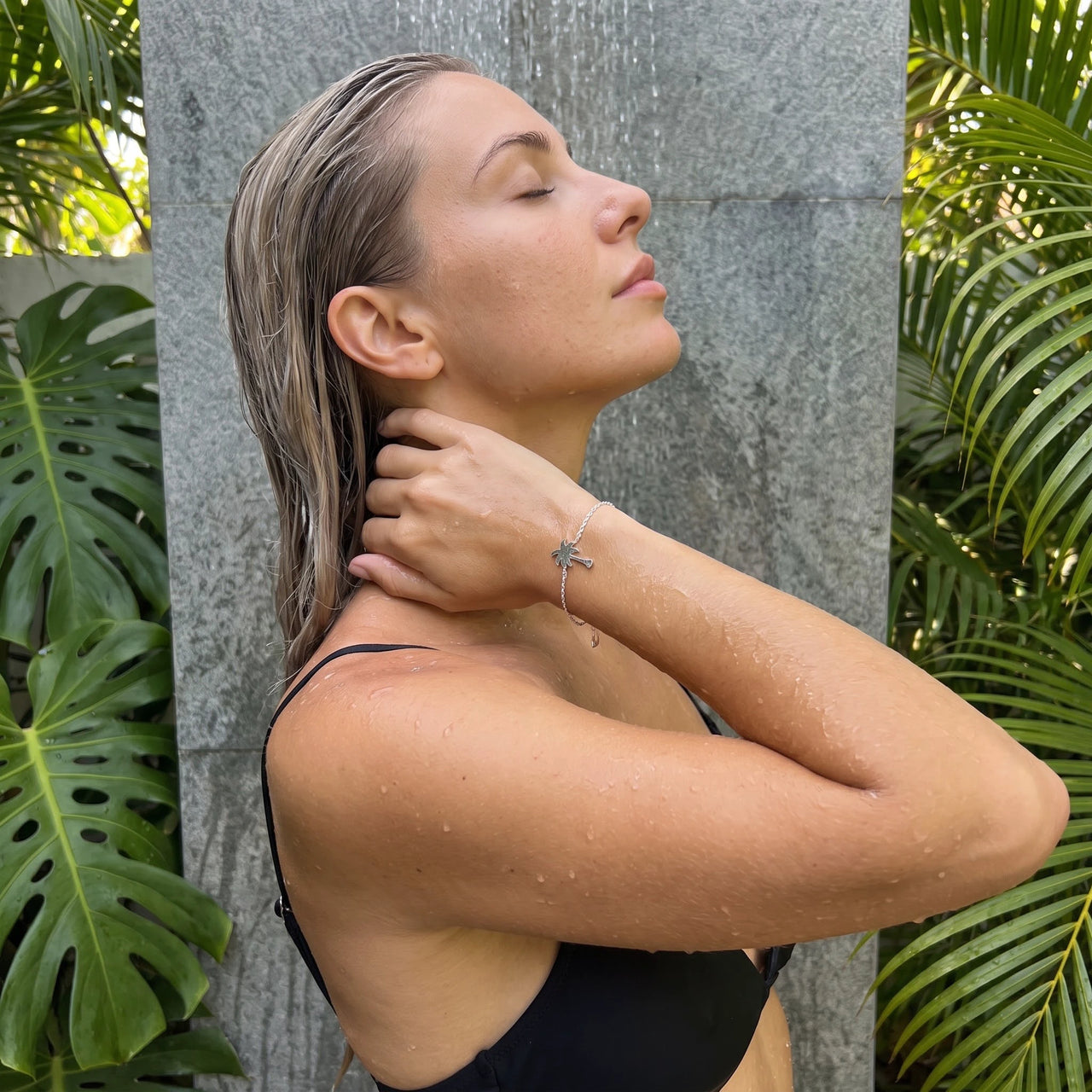 Silver charm bracelet worn in a tropical outdoor shower | SKU: 7819407-silver-plated