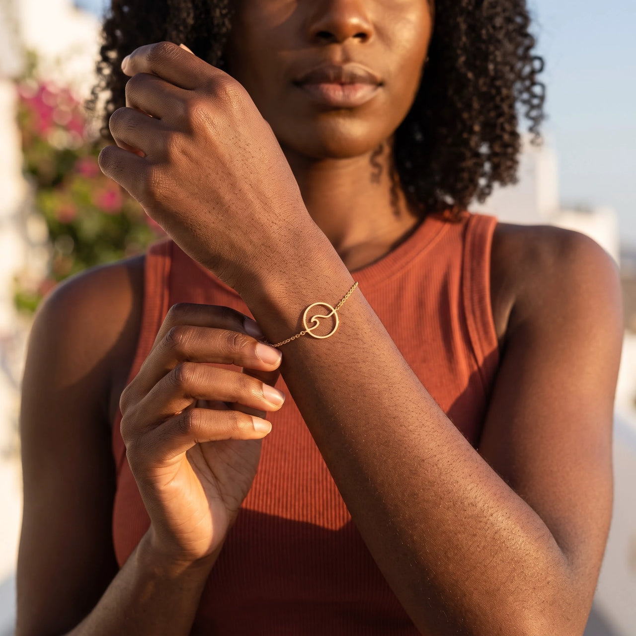 Woman gently touching her gold bracelet | SKU: 17429078-gold