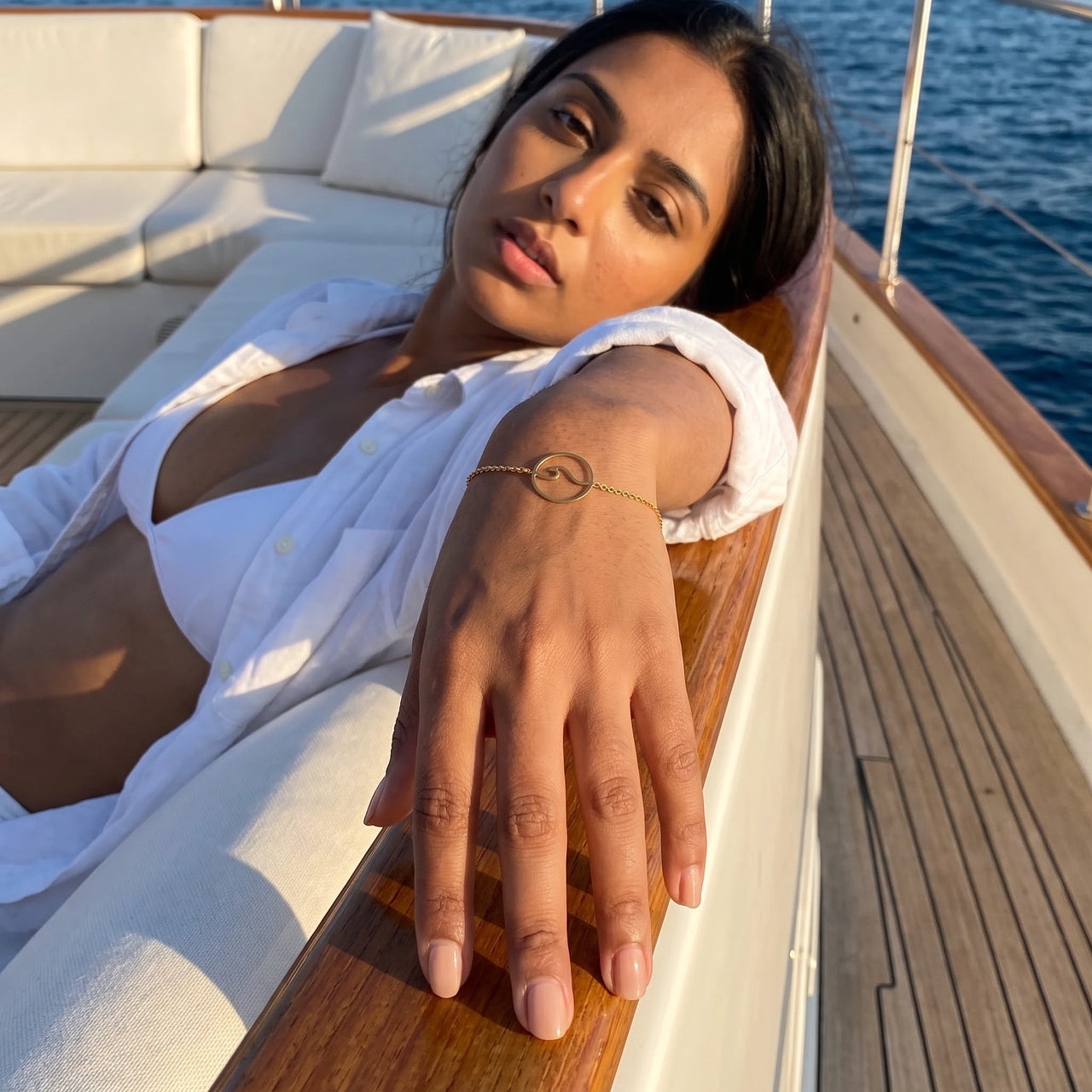 Woman on a yacht wearing the gold bracelet | SKU: 17429078-gold