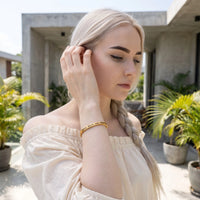 Thumbnail for Woman gently touching her Loyal, Brave, And, True bracelet in gold | SKU: lbat-g