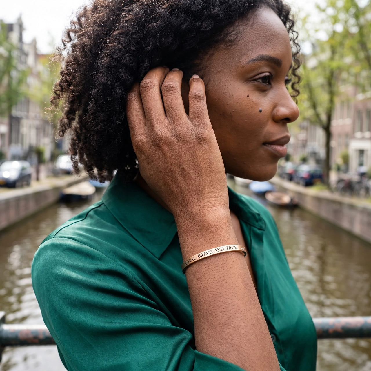 Woman gently touching her Loyal, Brave, And, True bracelet in rose gold | SKU: lbat-rg