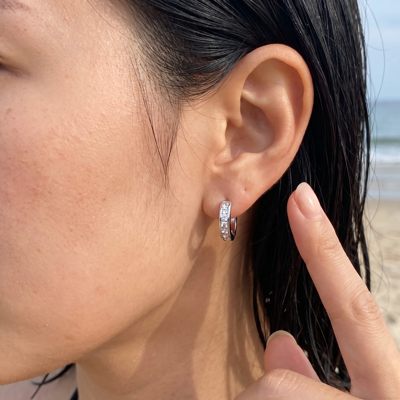 Silver huggie hoop earrings worn, showing its real size | SKU: 22023999-rhodium