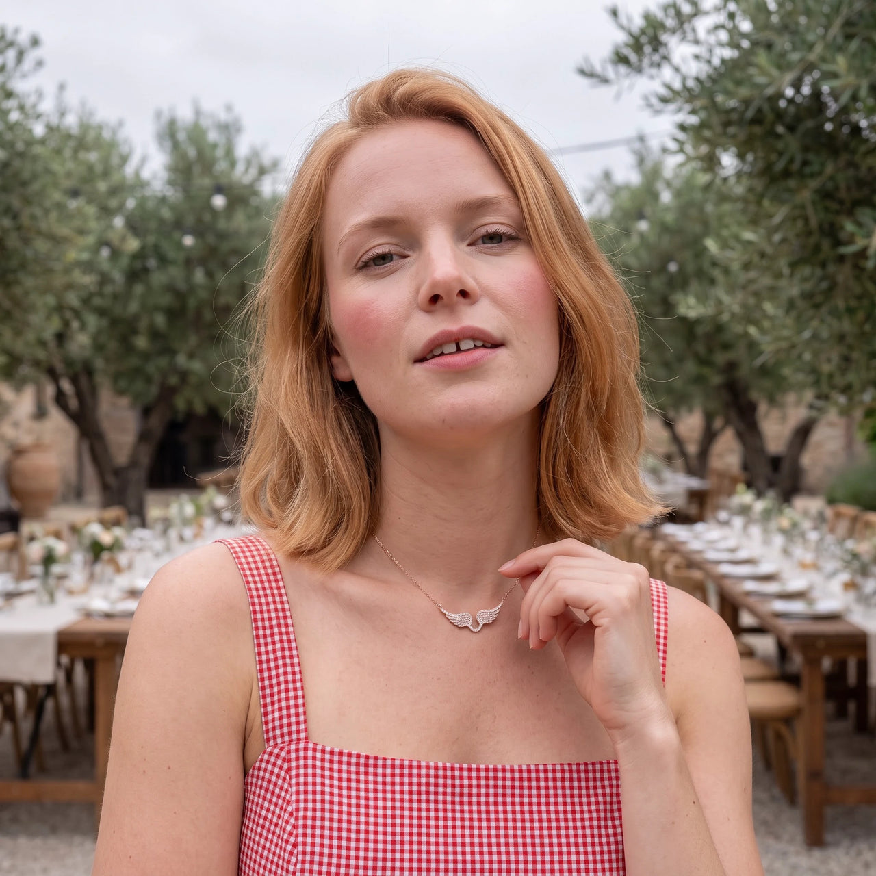 Woman gently touching her rose gold necklace | SKU: 42002-rose-gold