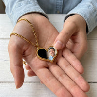 Thumbnail for Thumb warming the gold heart pendant: the hidden photo appears under the thumb while the rest stays black | SKU: TPH-HRTN-GOLD