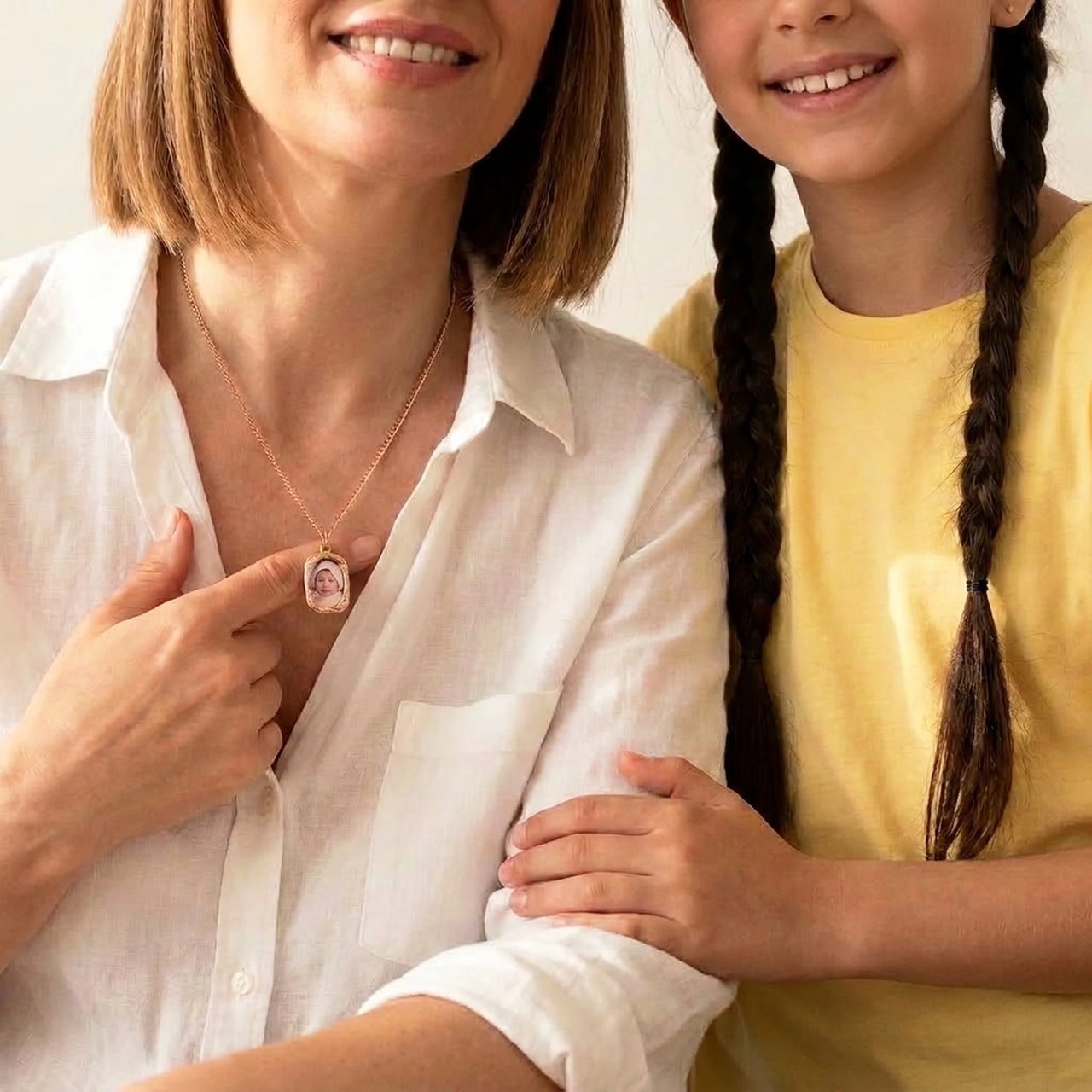 Mother and daughter sharing the photo hidden in the rose gold oval necklace | SKU: TPH-OVLN-ROSEGOLD