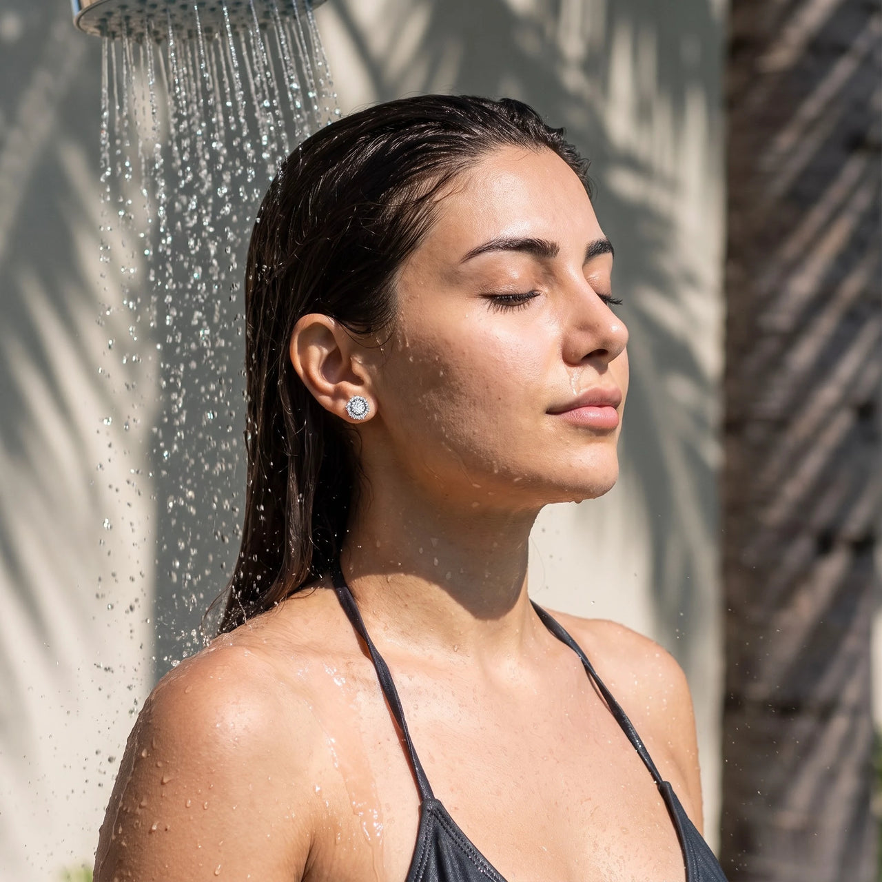Silver stud earrings worn under a tropical outdoor shower | SKU: 30876249