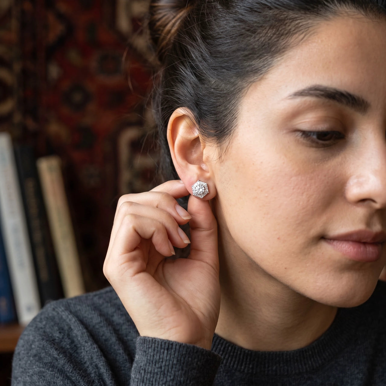 Woman gently touching her silver stud earrings | SKU: 30876249