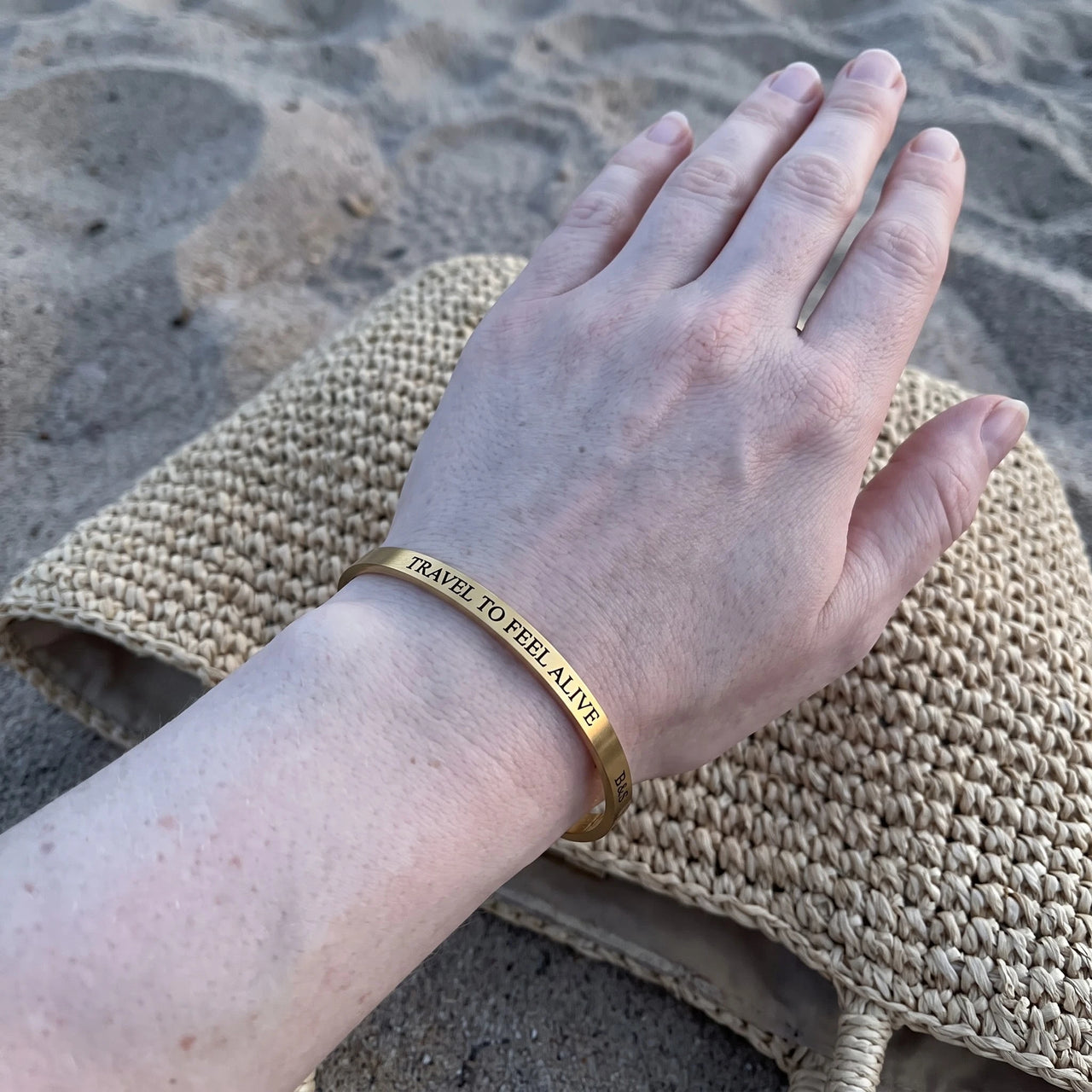Travel To Feel Alive bracelet in gold worn, showing its real size | SKU: ttfa-g