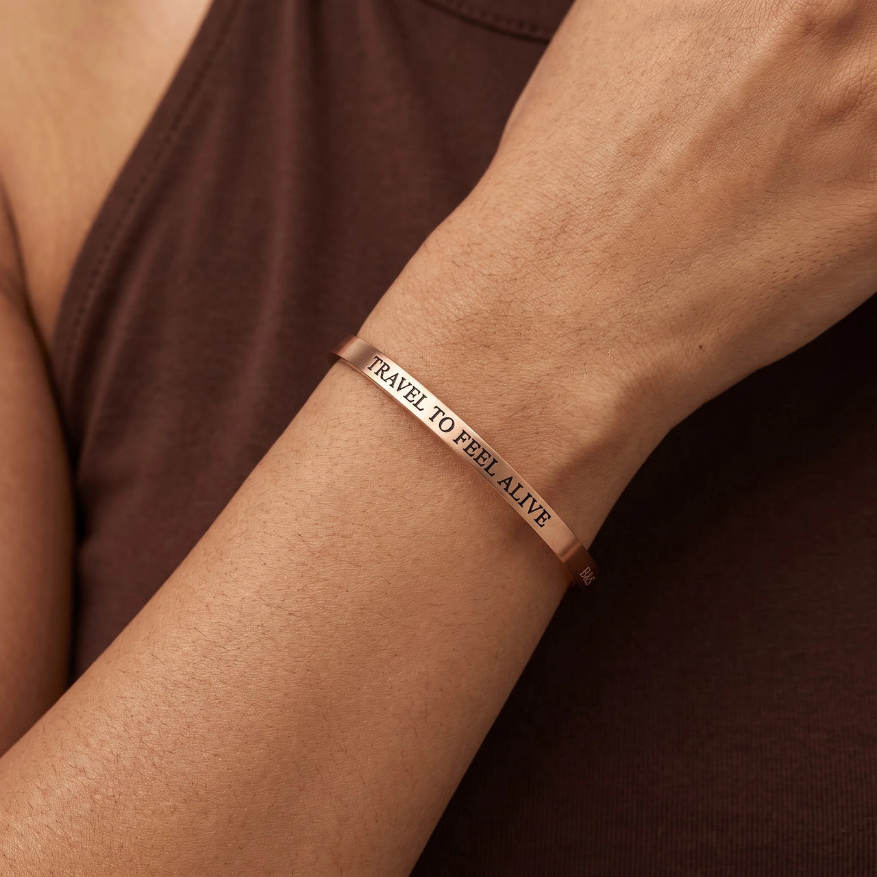 Close-up of the Travel To Feel Alive bracelet in rose gold worn | SKU: ttfa-rg